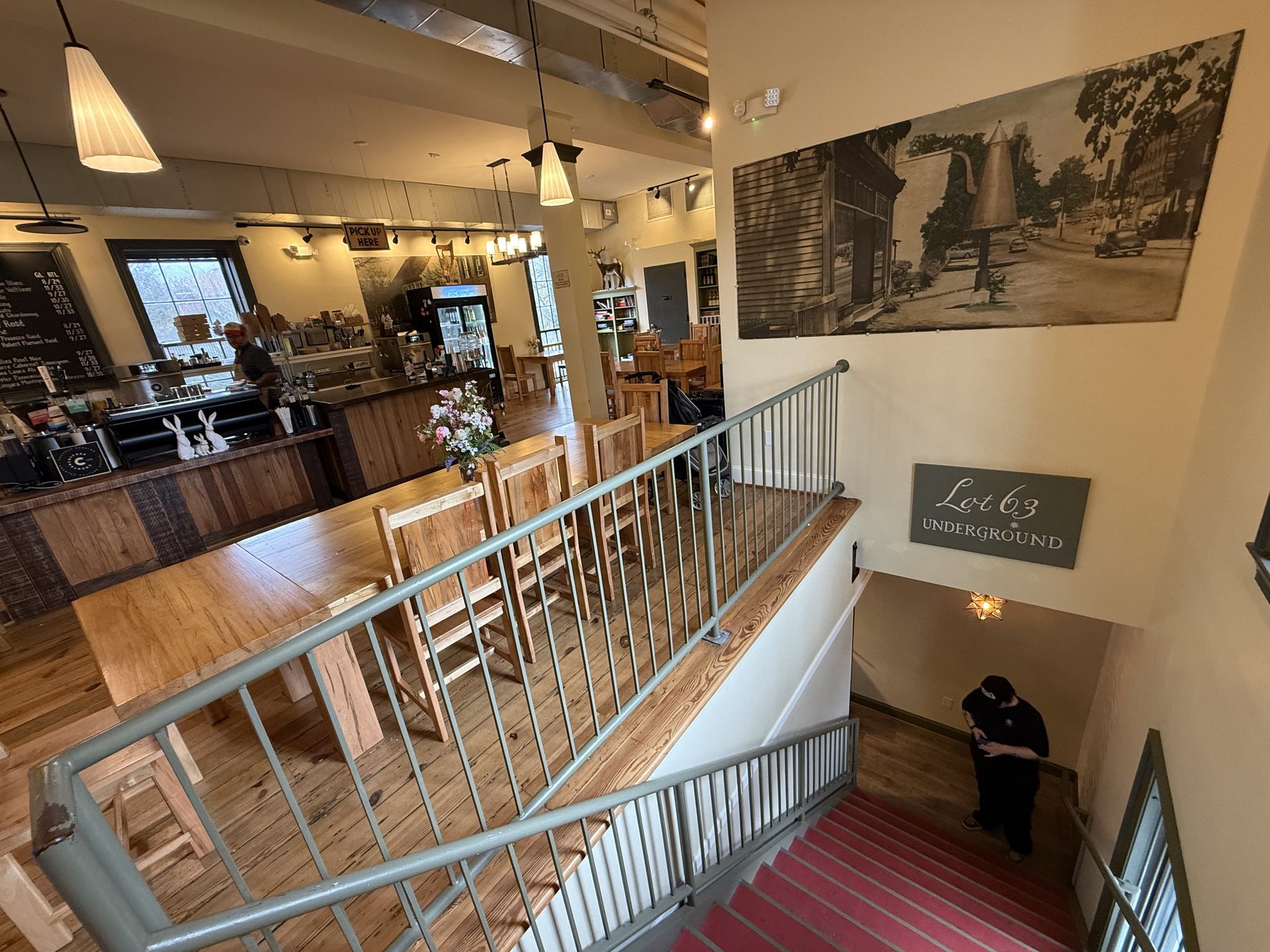 Interior of Lot 63 Underground in Old Salem — wood tables, hanging lights, historic brick walls