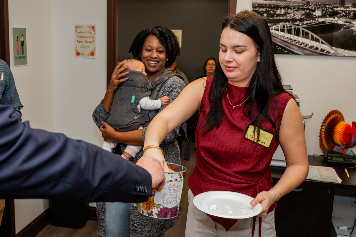 Team member raffling off a prize at the Thanksgiving open house