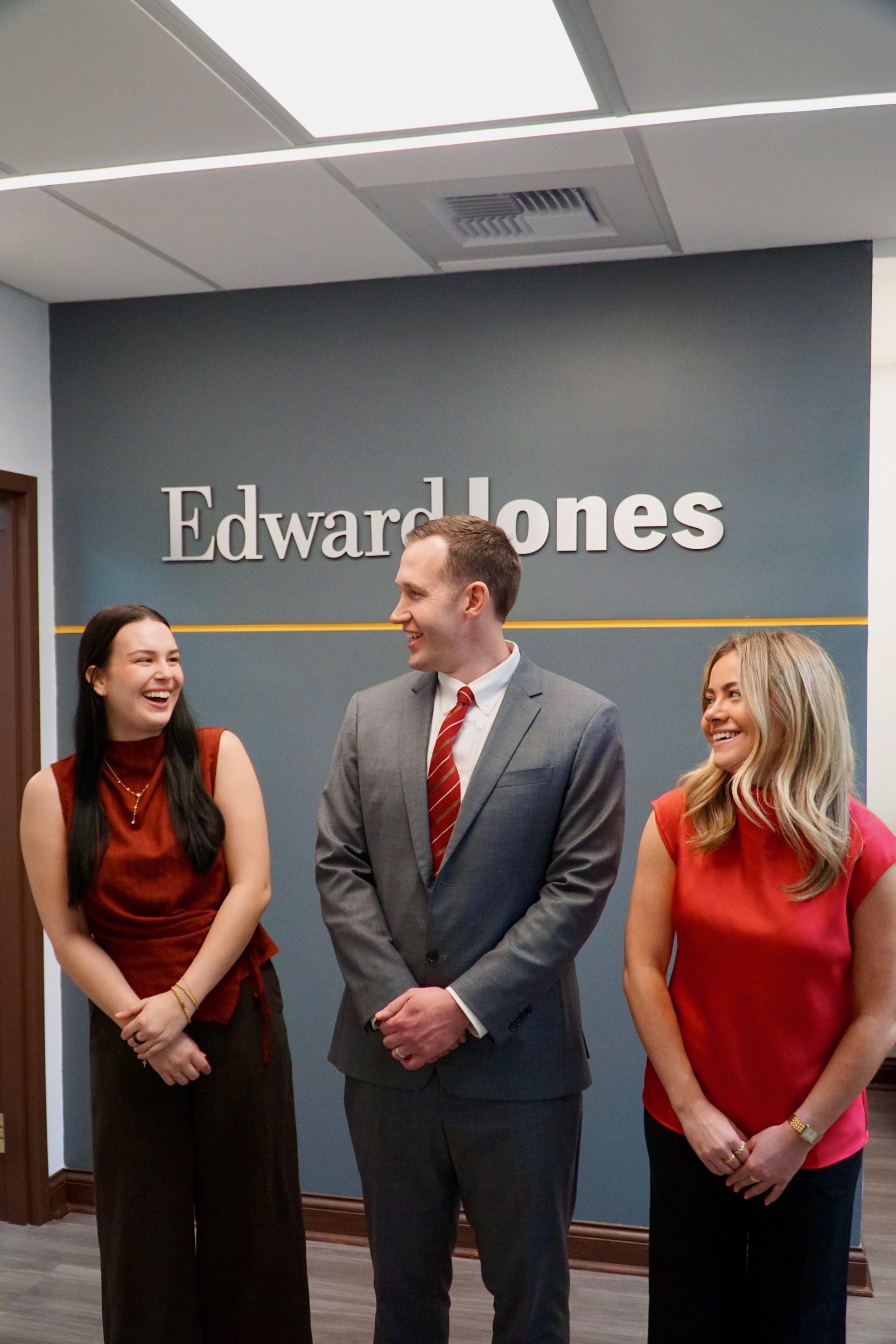 Joe Lotozo, Emma Reed, and Bella Cloyd laughing together at the office