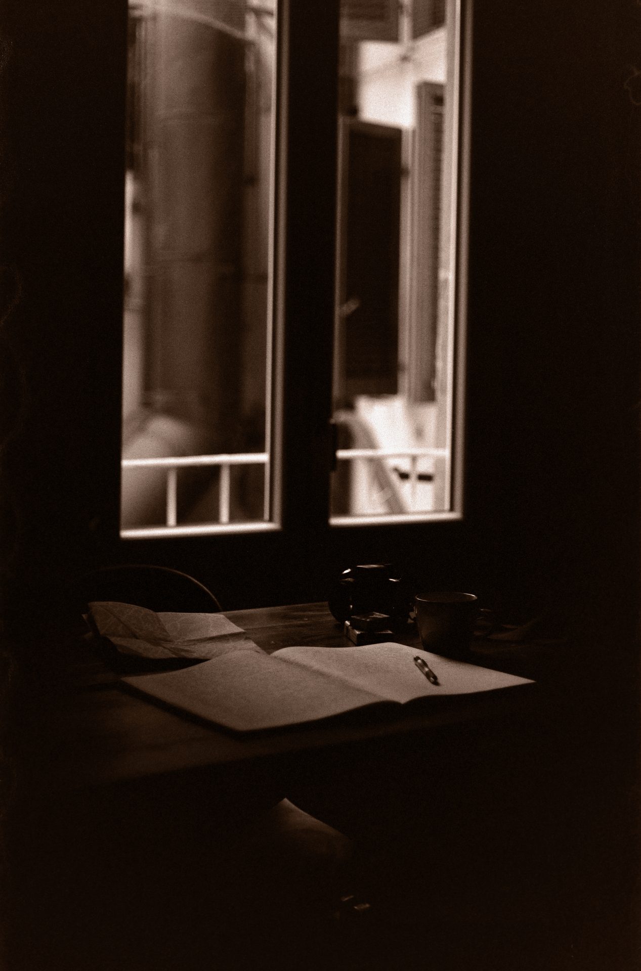 Open book beside a café window in Florence, morning light — 35mm film