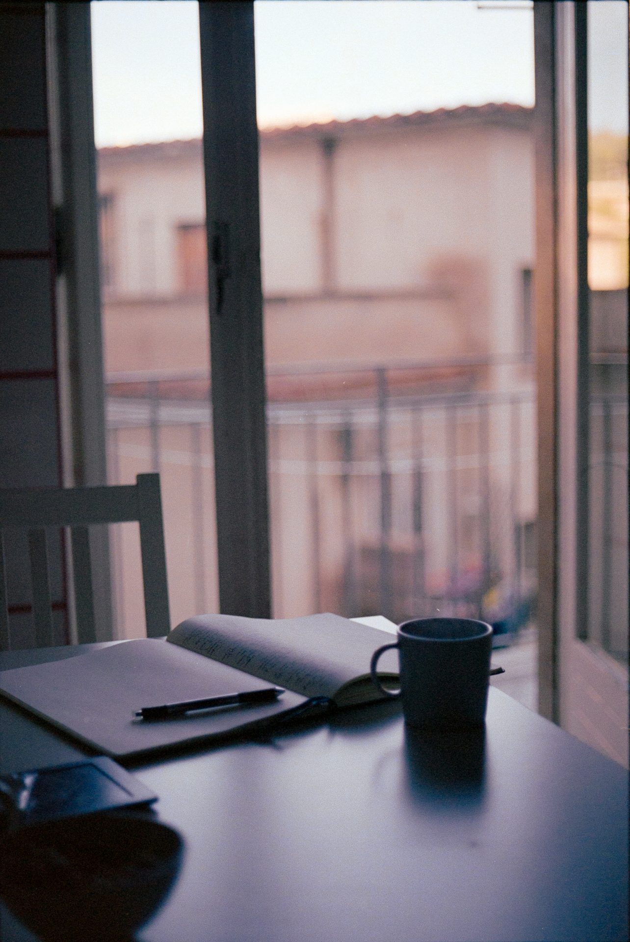 Coffee and notebook on an Italian balcony at golden hour — Kodak film, Italy 2022