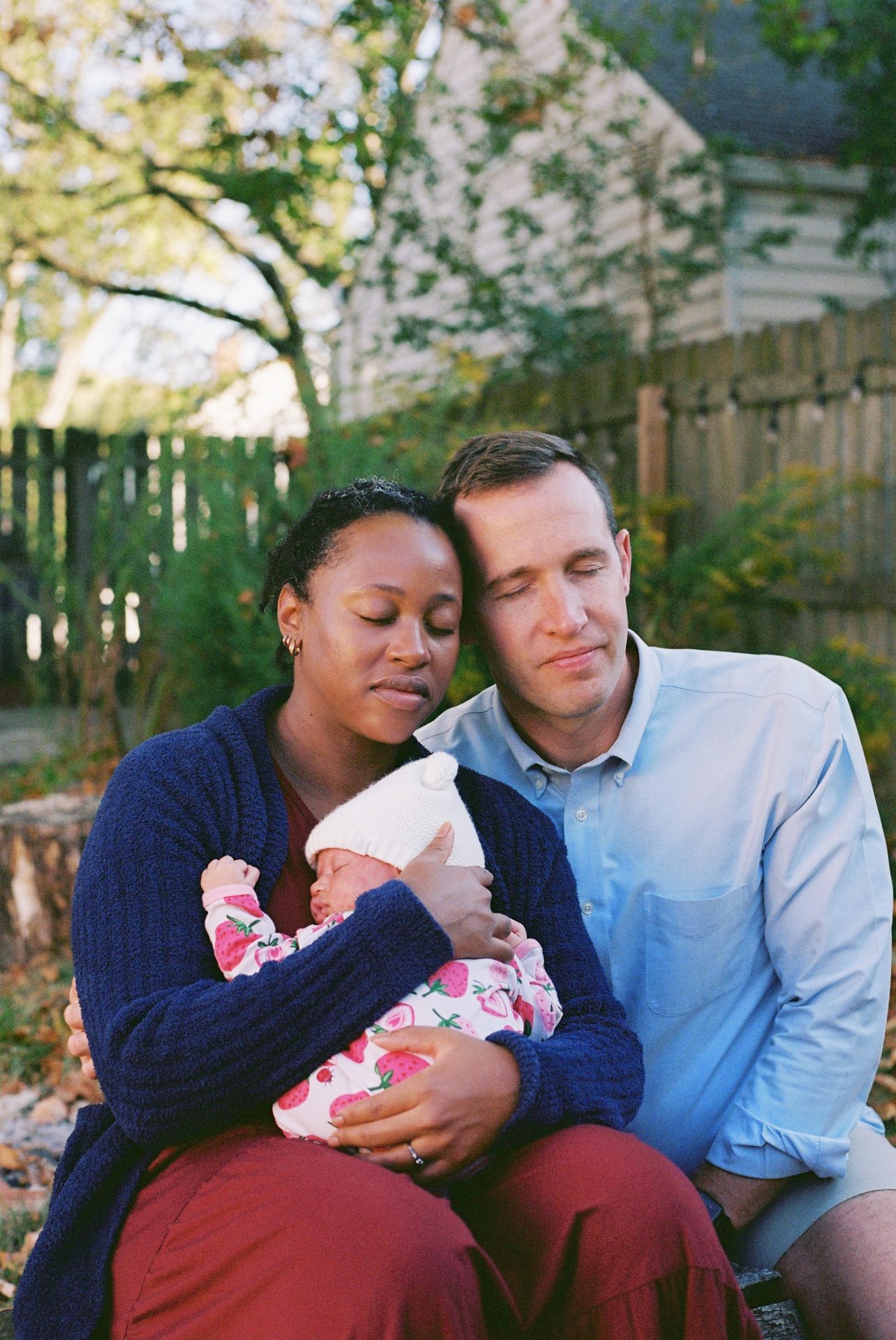 A couple with their newborn in the backyard, October — 35mm film portrait session