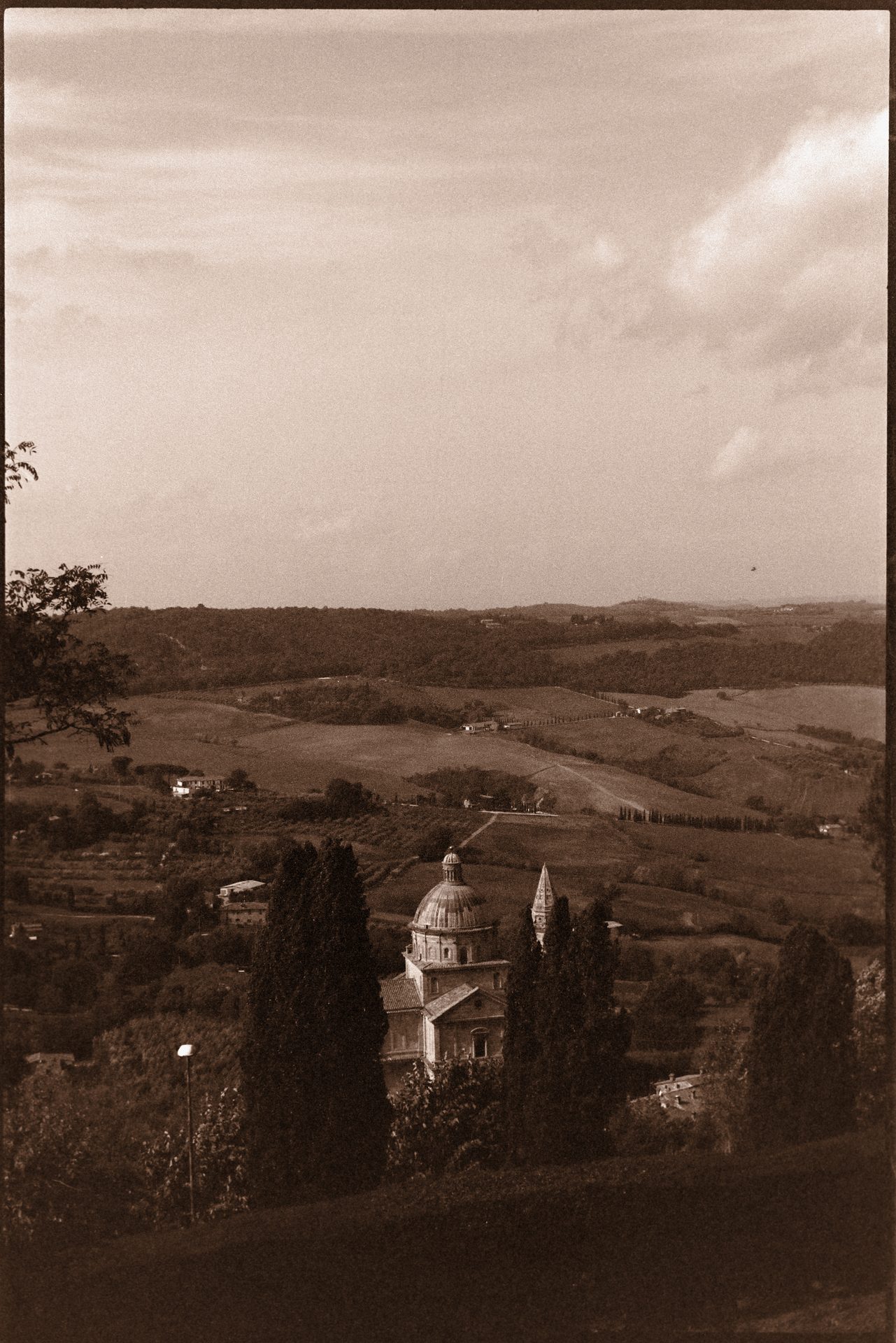 Tuscan hilltop church with rolling countryside and cypress trees — 35mm film, Italy 2022